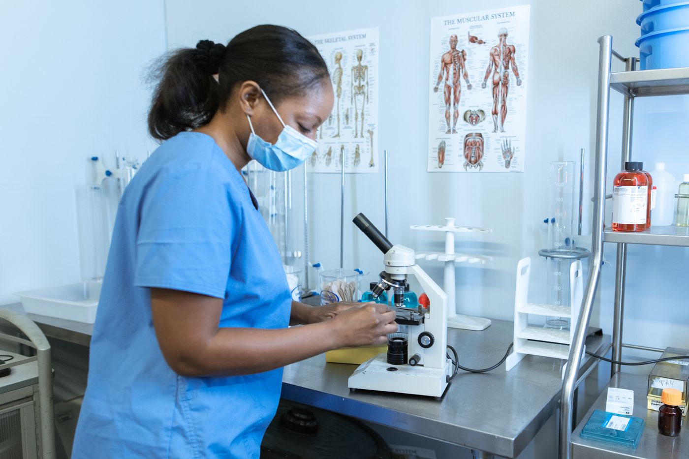 Laboratory professional working with a microscope